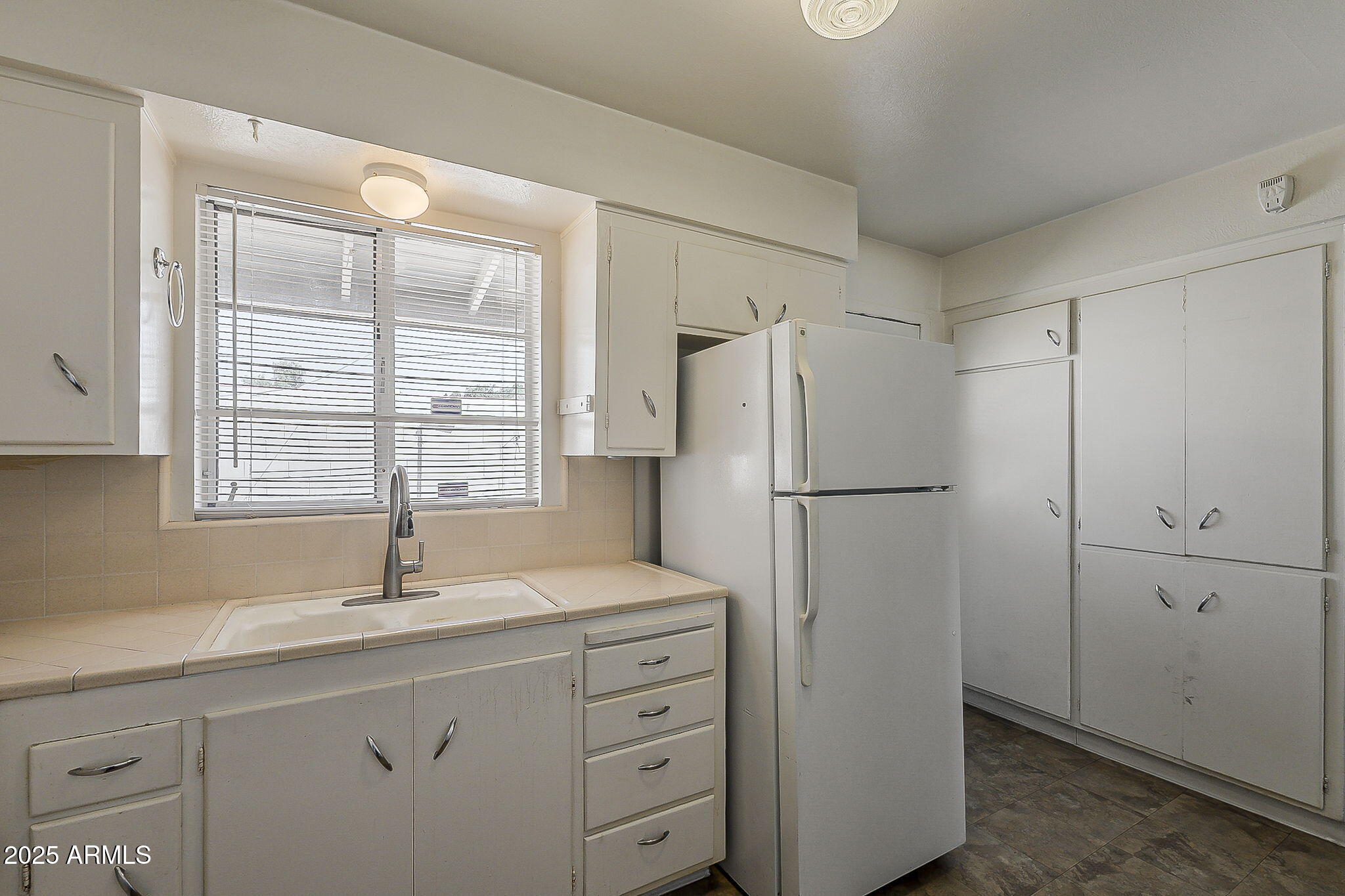 6225 North 10th Place Phoenix, AZ 85014 - Photo 16 of 32 a kitchen with a refrigerator and a sink