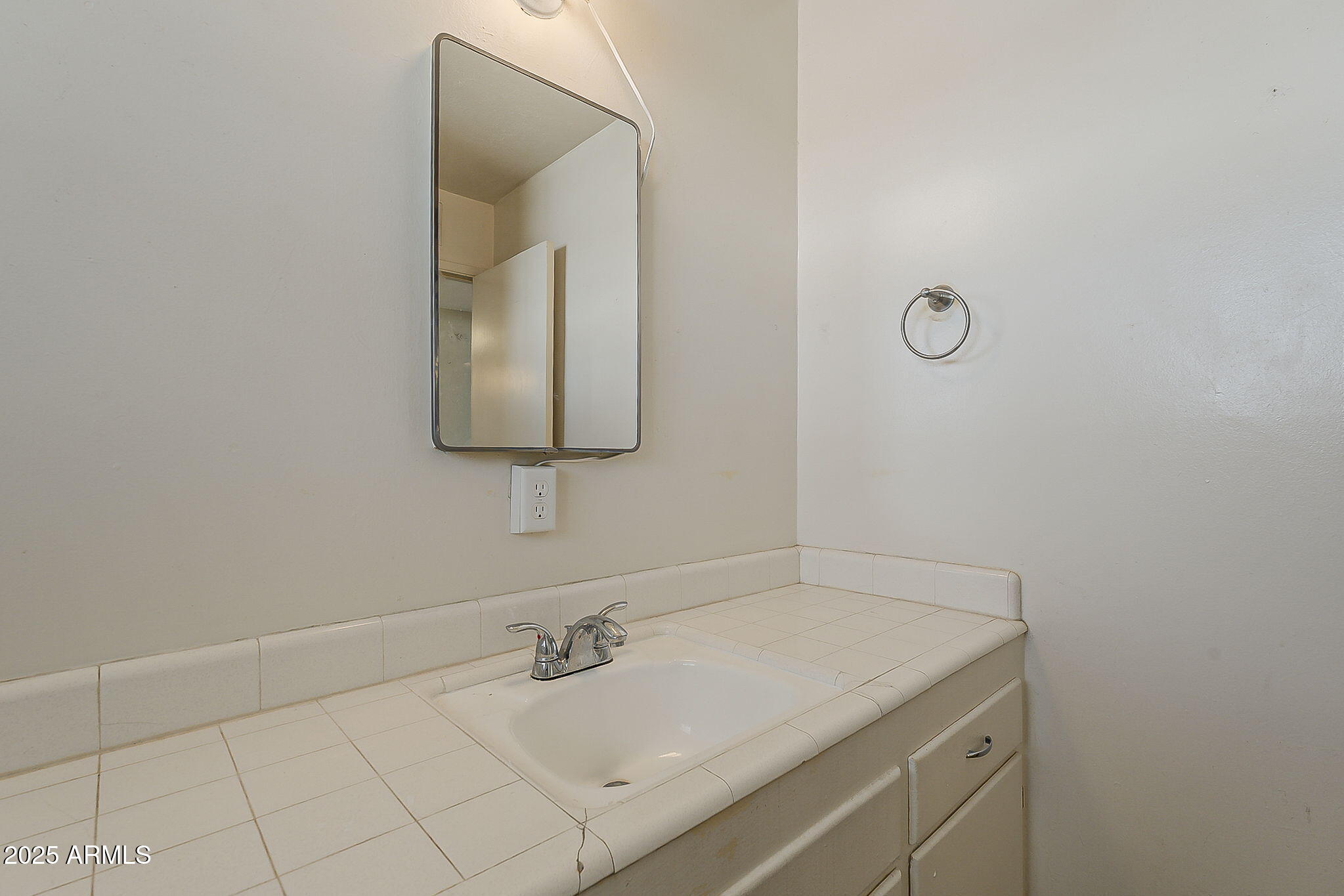 6225 North 10th Place Phoenix, AZ 85014 - Photo 21 of 32 a bathroom with a granite countertop sink and a mirror