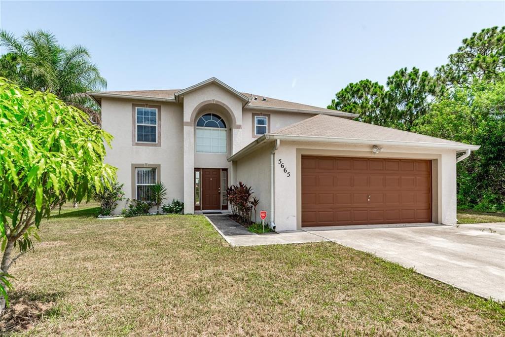 5665 Northwest Whitecap Road Port St. Lucie, FL 34986 - Photo 1 of 25 a view of a house with a yard