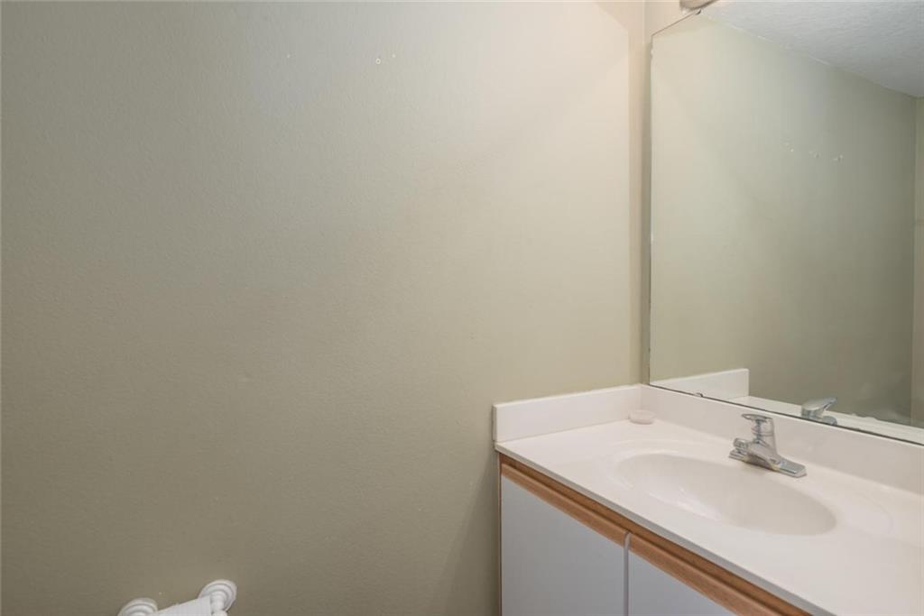 5665 Northwest Whitecap Road Port St. Lucie, FL 34986 - Photo 12 of 25 a bathroom with a sink and a mirror