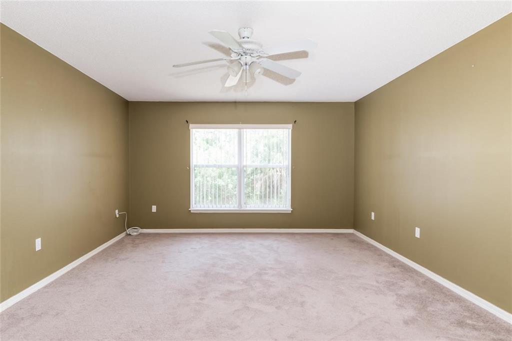 5665 Northwest Whitecap Road Port St. Lucie, FL 34986 - Photo 14 of 25 an empty room with a ceiling fan and window