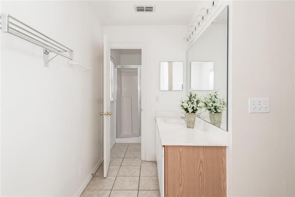 5665 Northwest Whitecap Road Port St. Lucie, FL 34986 - Photo 15 of 25 a bathroom with a sink and mirror