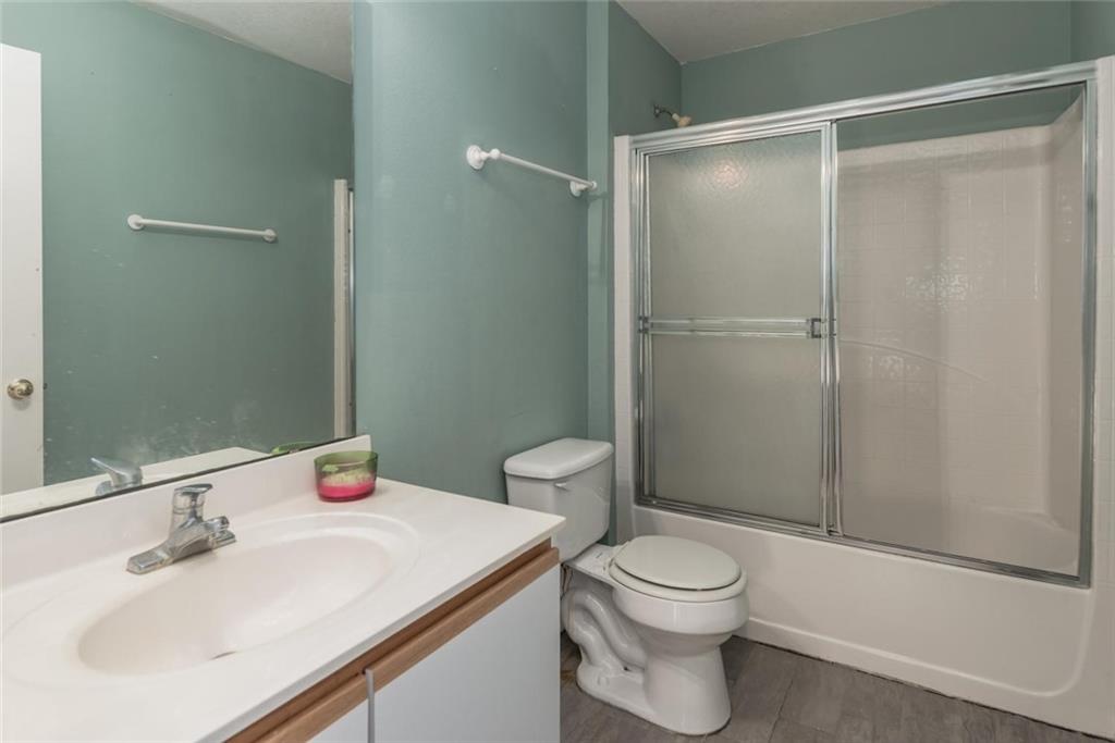 5665 Northwest Whitecap Road Port St. Lucie, FL 34986 - Photo 18 of 25 a bathroom with a sink a toilet and shower