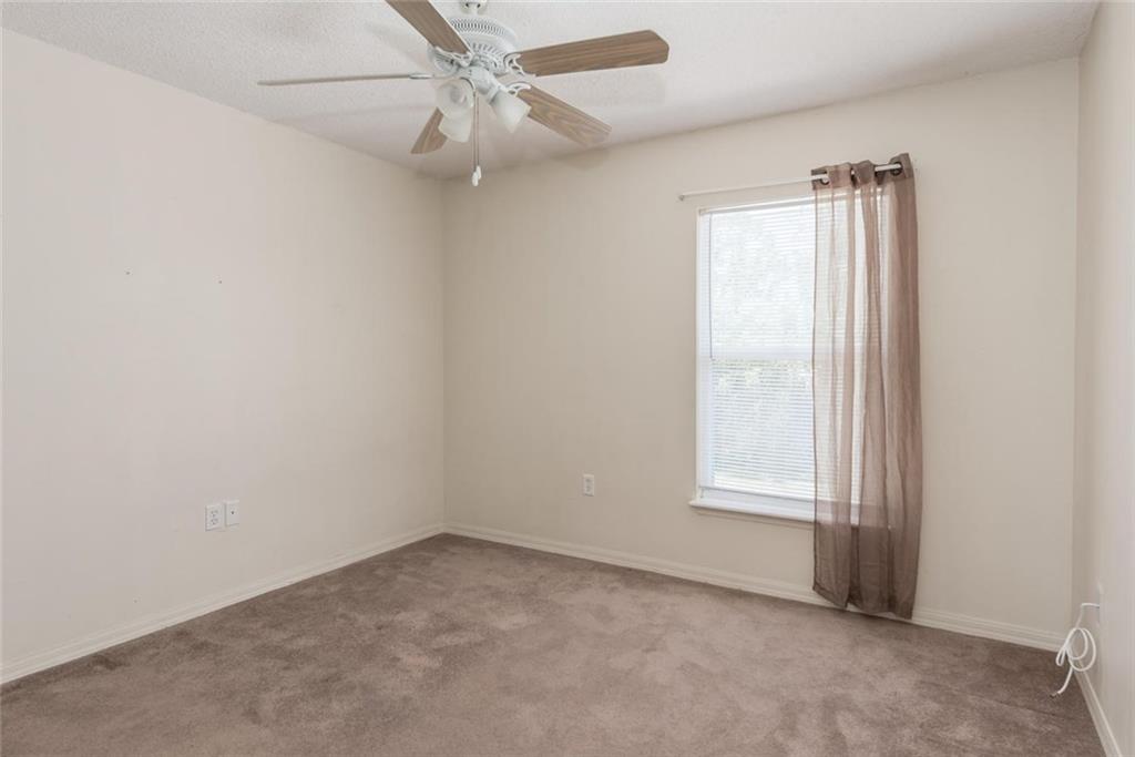 5665 Northwest Whitecap Road Port St. Lucie, FL 34986 - Photo 19 of 25 an empty room with windows and fan