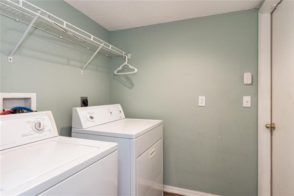 5665 Northwest Whitecap Road Port St. Lucie, FL 34986 - Photo 21 of 25 a utility room with dryer and washer