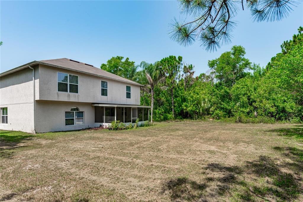 5665 Northwest Whitecap Road Port St. Lucie, FL 34986 - Photo 25 of 25 a front view of a house with a yard