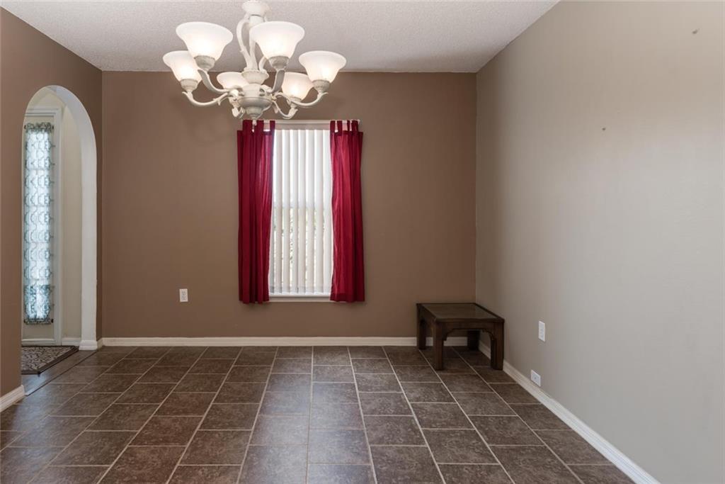 5665 Northwest Whitecap Road Port St. Lucie, FL 34986 - Photo 3 of 25 a view of a room with a chandelier furniture and windows