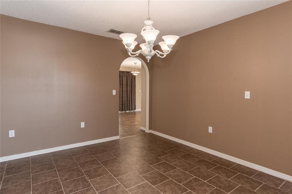 5665 Northwest Whitecap Road Port St. Lucie, FL 34986 - Photo 4 of 25 a view of a chandelier in big room and chandelier