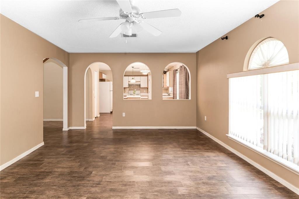5665 Northwest Whitecap Road Port St. Lucie, FL 34986 - Photo 6 of 25 an empty room with wooden floor and windows