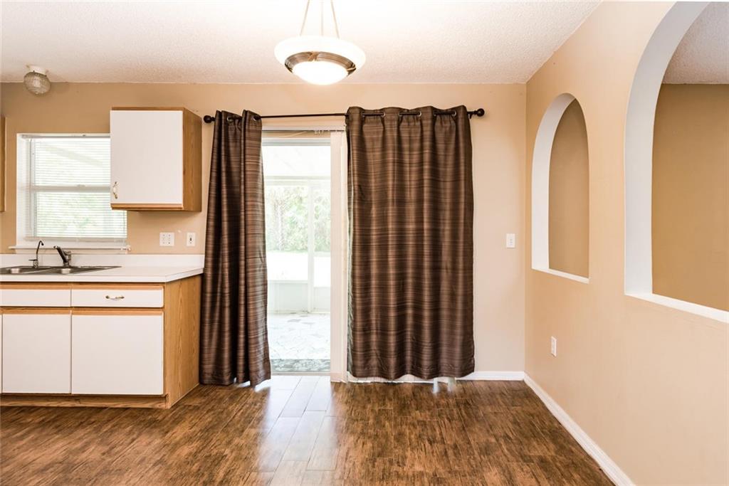5665 Northwest Whitecap Road Port St. Lucie, FL 34986 - Photo 8 of 25 a view of a kitchen with wooden floor and a window