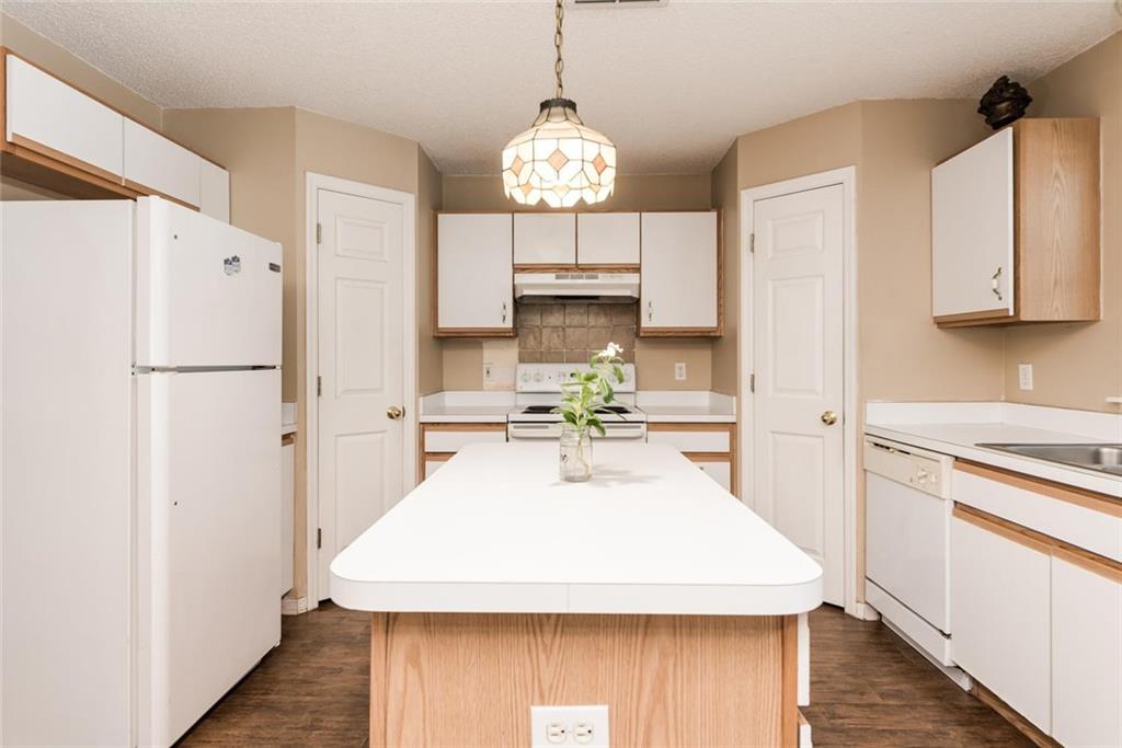 5665 Northwest Whitecap Road Port St. Lucie, FL 34986 - Photo 9 of 25 a kitchen with refrigerator and cabinets