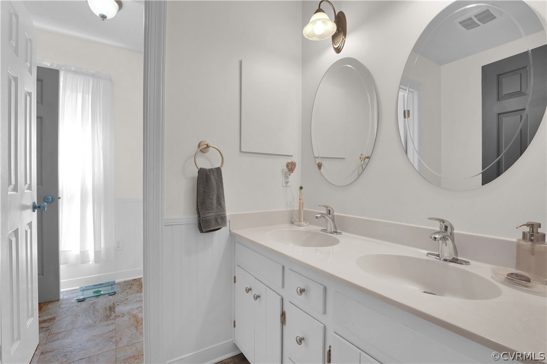 13113 Bluemont Road Chester, VA 23831 - Photo 20 of 41 a bathroom with double vanity sinks and a mirror