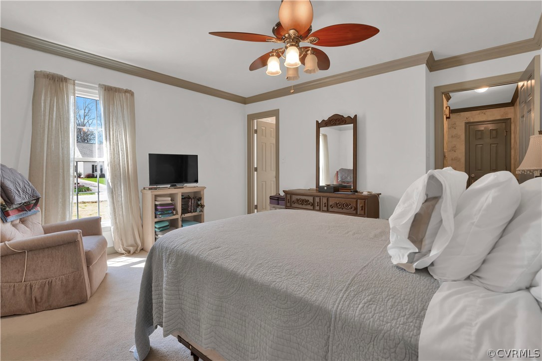 13113 Bluemont Road Chester, VA 23831 - Photo 23 of 41 a bedroom with a bed a chandelier and a flat screen television