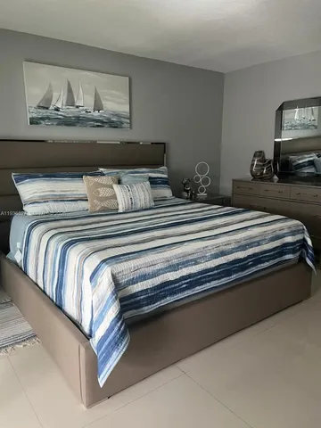 a bedroom with a bed and dresser