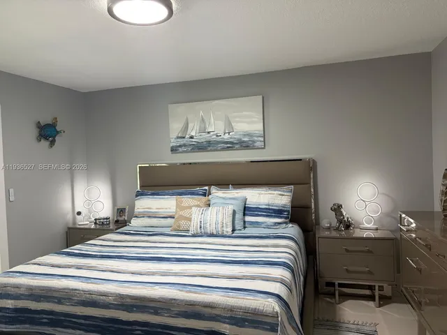 a bedroom with a bed and lamp