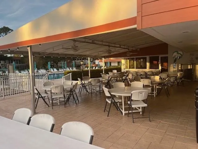 a view of a patio with dining table and chairs