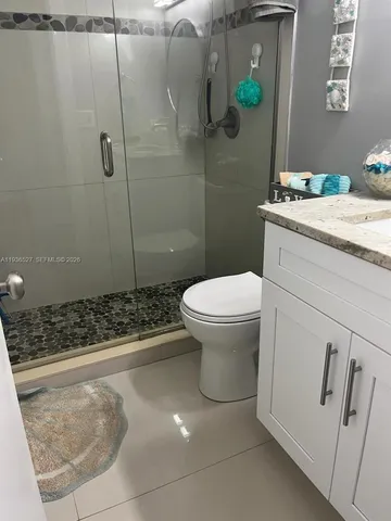 a bathroom with a sink toilet and shower