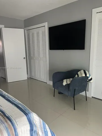 a bedroom with a bed and a television