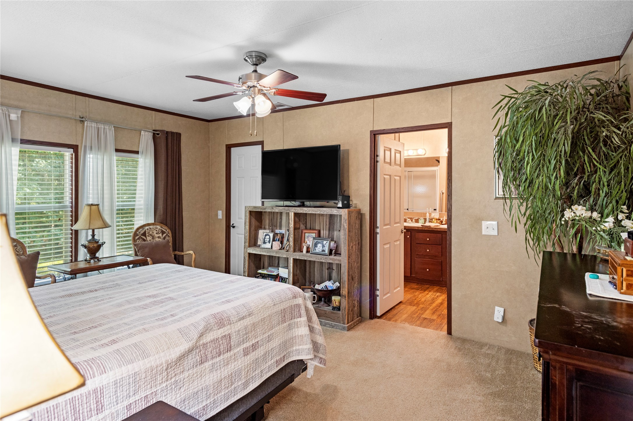 375 Chestnut Bnd Street Huntsville, TX 77320 - Photo 17 of 35 a bedroom with a large bed and a flat tv screen on dresser