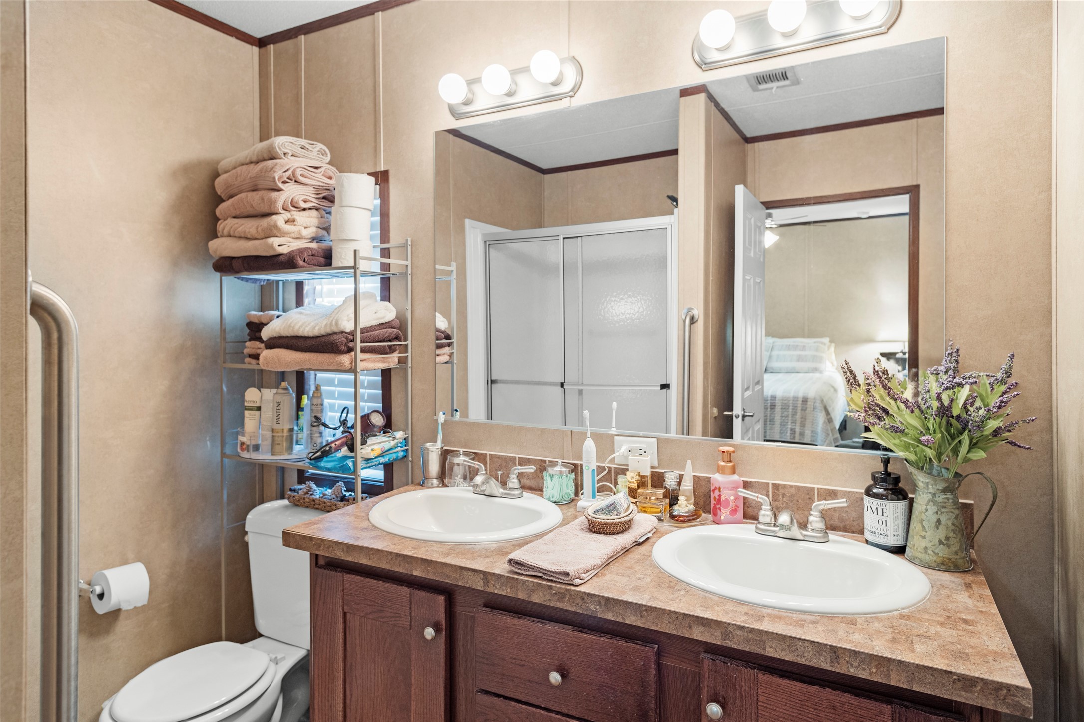 375 Chestnut Bnd Street Huntsville, TX 77320 - Photo 18 of 35 a bathroom with a granite countertop sink a toilet and a mirror