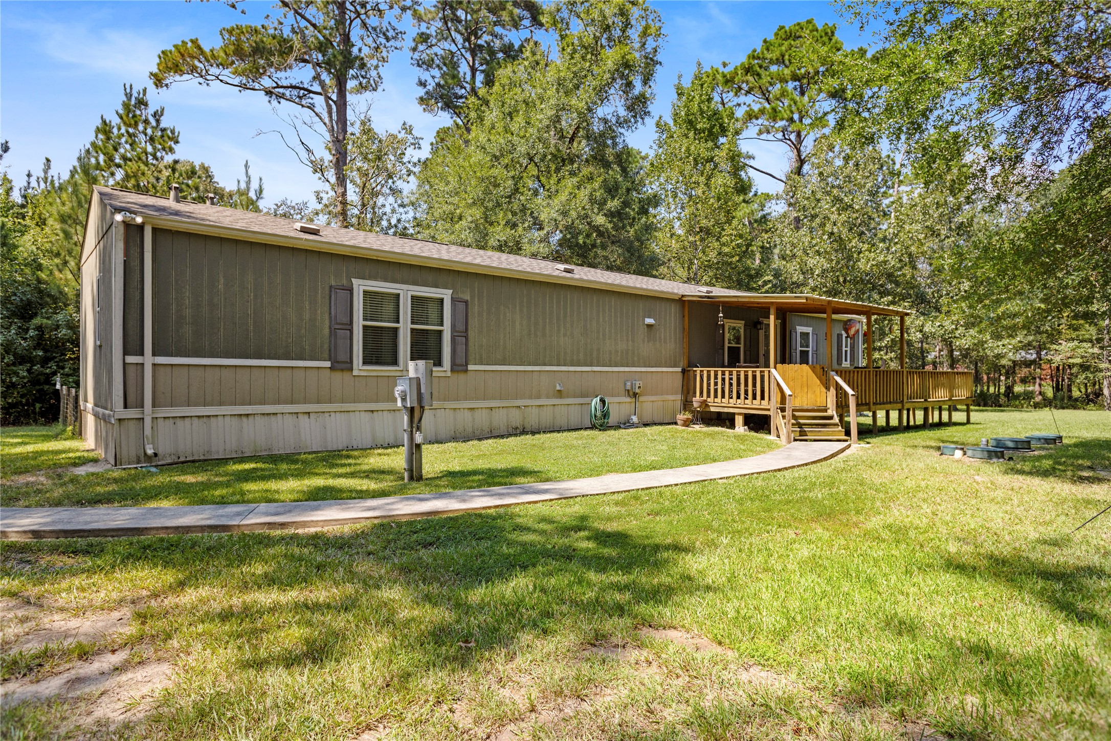 375 Chestnut Bnd Street Huntsville, TX 77320 - Photo 3 of 35 a view of a house with backyard and trees