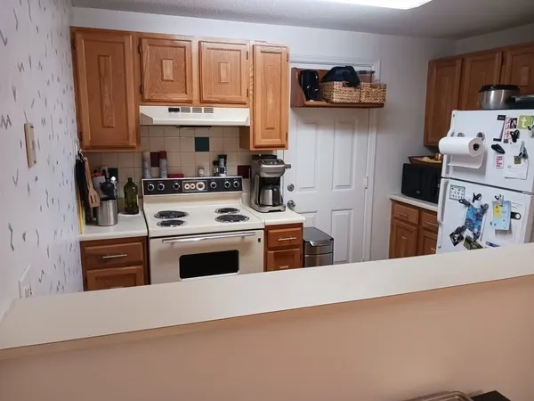 a kitchen with stainless steel appliances granite countertop a stove and a refrigerator