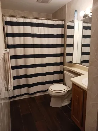a bathroom with a toilet and a shower