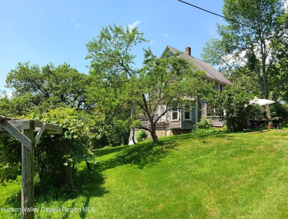 a view of a house with a backyard