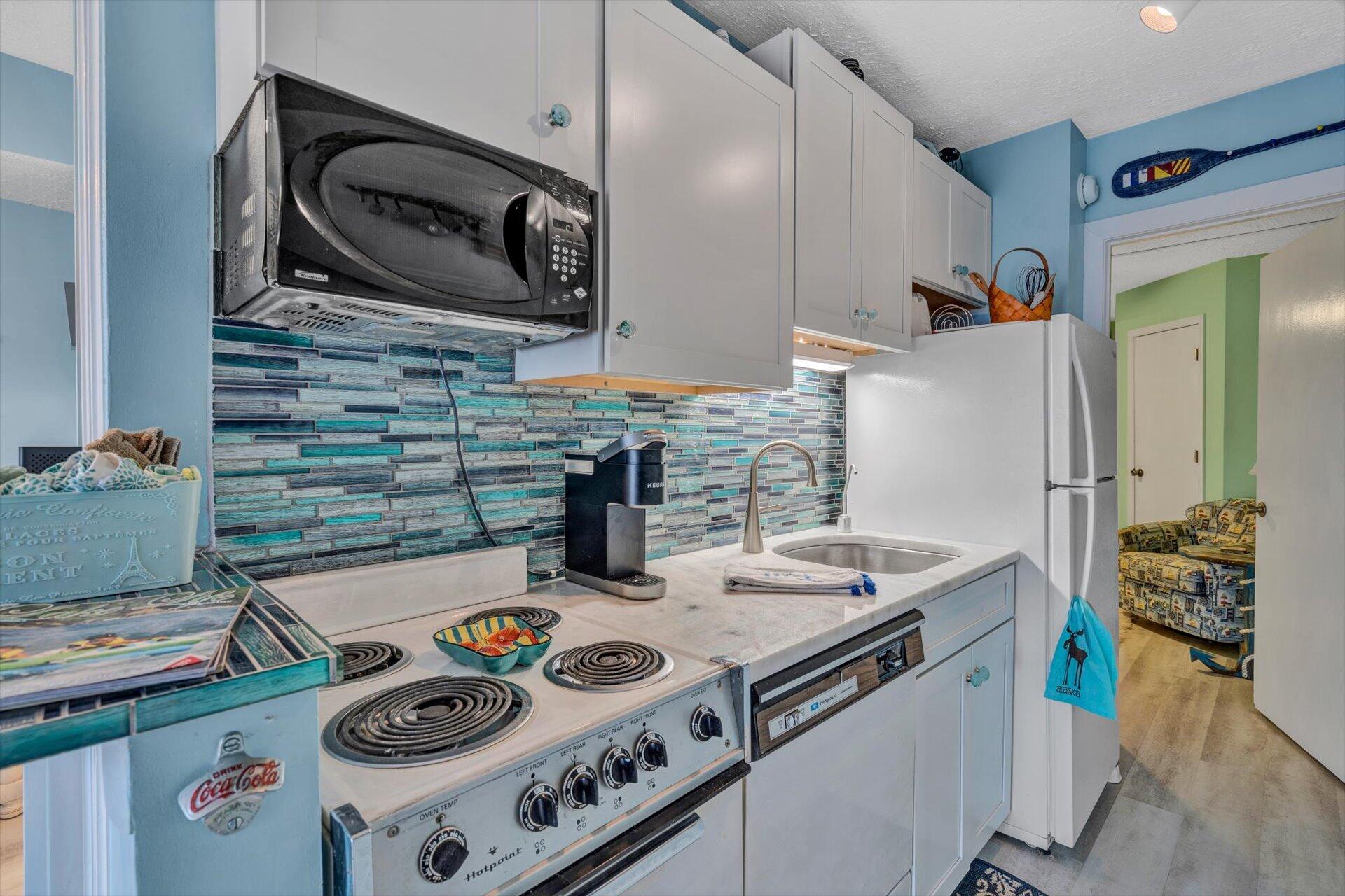 1089 Bluewater Drive, Unit 305 Moneta, VA 24121 - Photo 12 of 41 a kitchen with a stove and a microwave