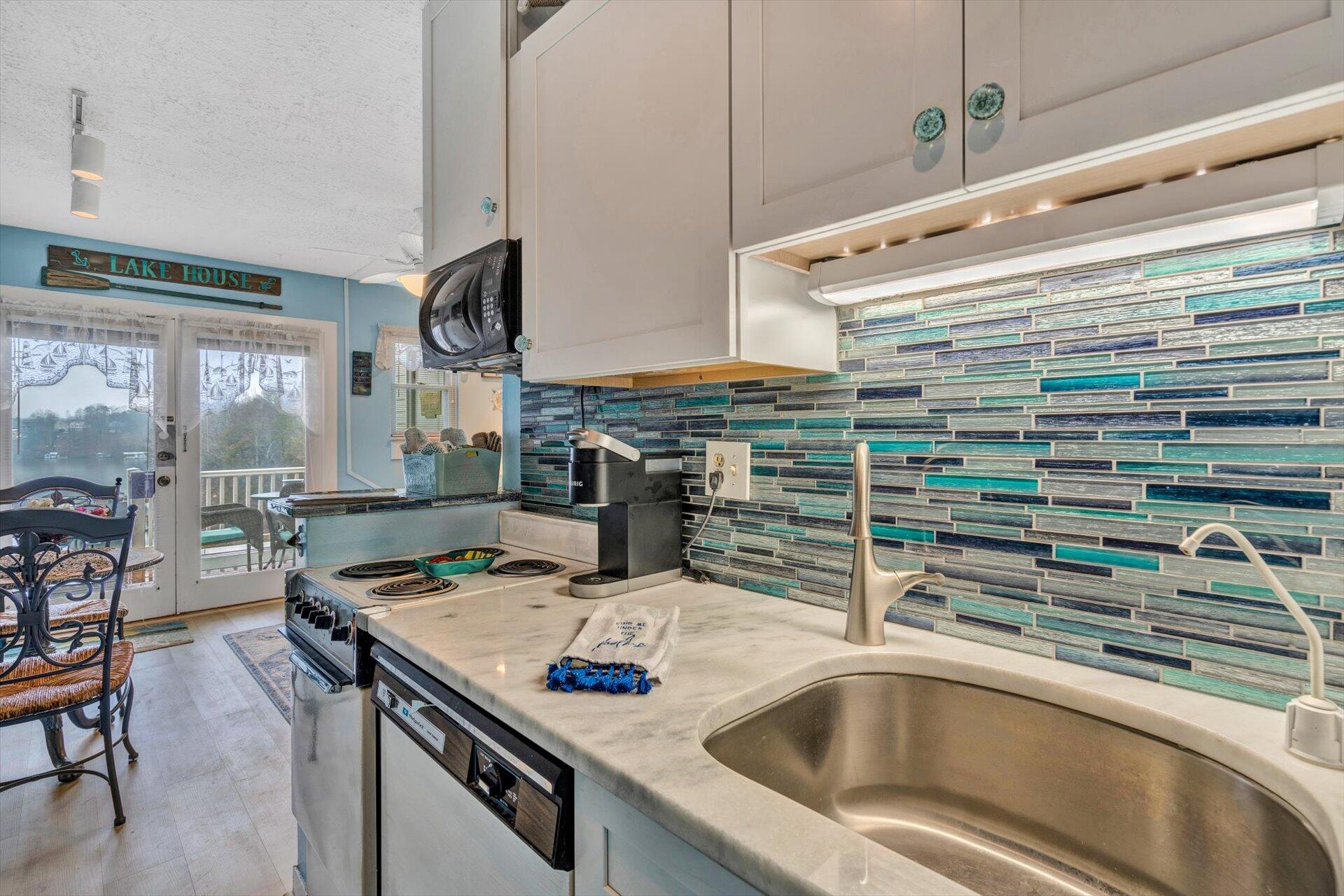 1089 Bluewater Drive, Unit 305 Moneta, VA 24121 - Photo 13 of 41 a kitchen with a sink and a stove top oven