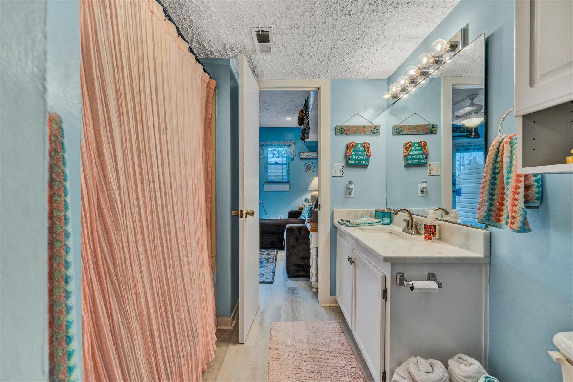 1089 Bluewater Drive, Unit 305 Moneta, VA 24121 - Photo 17 of 41 a bathroom with a sink a toilet and shower