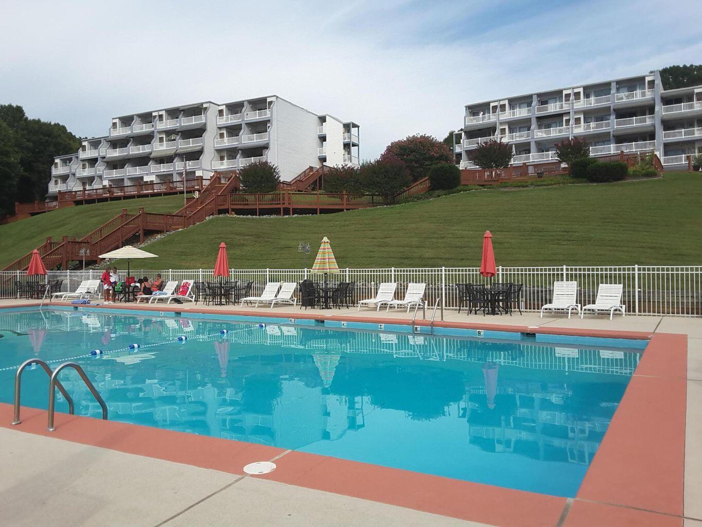 1089 Bluewater Drive, Unit 305 Moneta, VA 24121 - Photo 19 of 41 a view of a lake with a houses yard and lake view