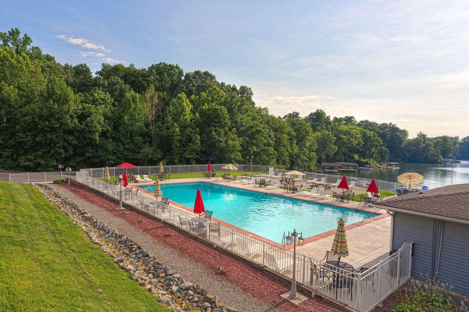 1089 Bluewater Drive, Unit 305 Moneta, VA 24121 - Photo 21 of 41 a view of a swimming pool with a terrace and a garden