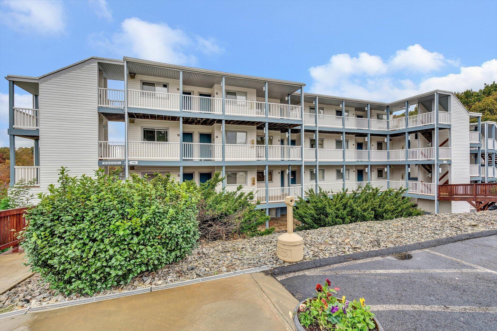 1089 Bluewater Drive, Unit 305 Moneta, VA 24121 - Photo 29 of 41 front view of a building with a garden