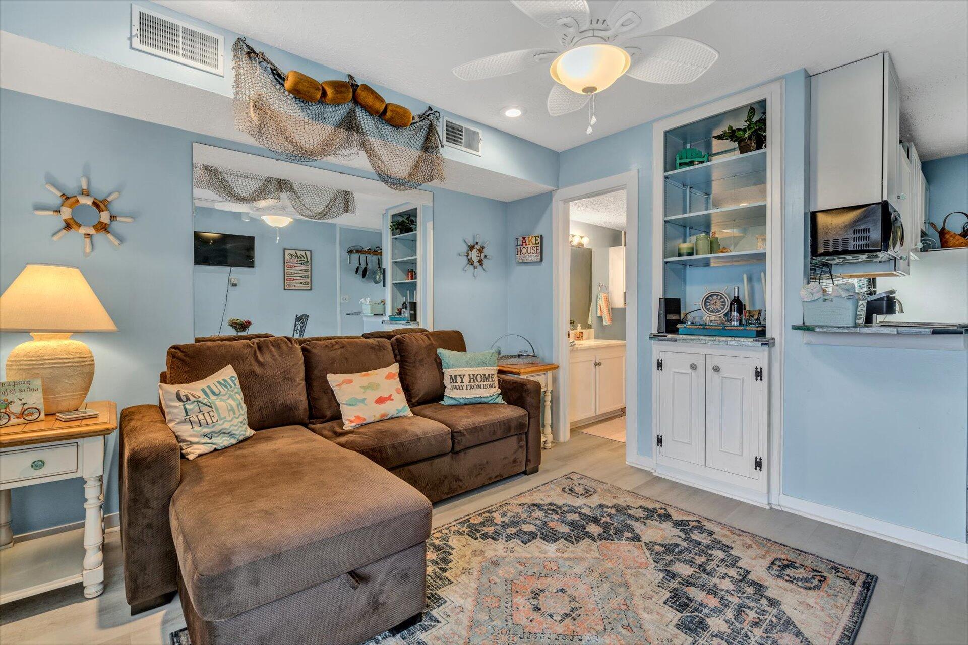 1089 Bluewater Drive, Unit 305 Moneta, VA 24121 - Photo 9 of 41 a living room with furniture and a chandelier