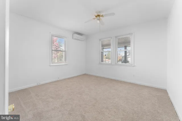 an empty room with windows and closet