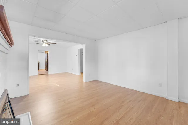 a view of an empty room and wooden floor