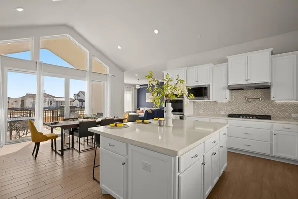 a kitchen with a sink stove and cabinets