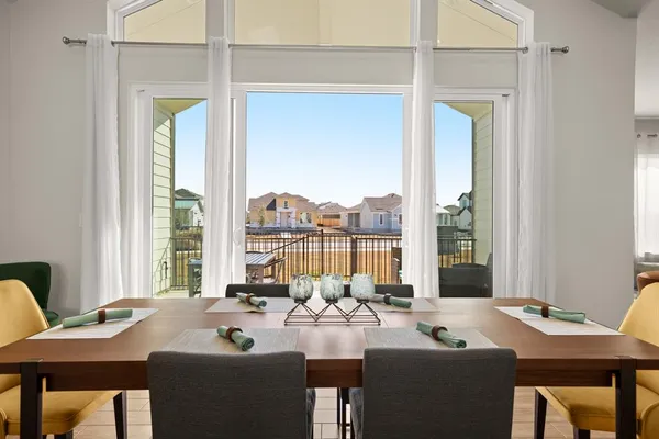 a dining room with furniture and window
