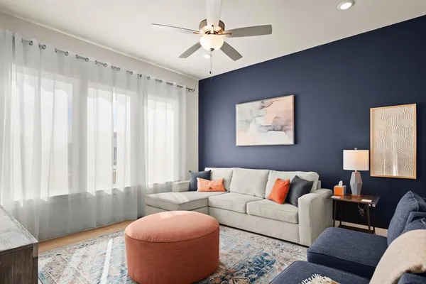 a living room with furniture and a large window