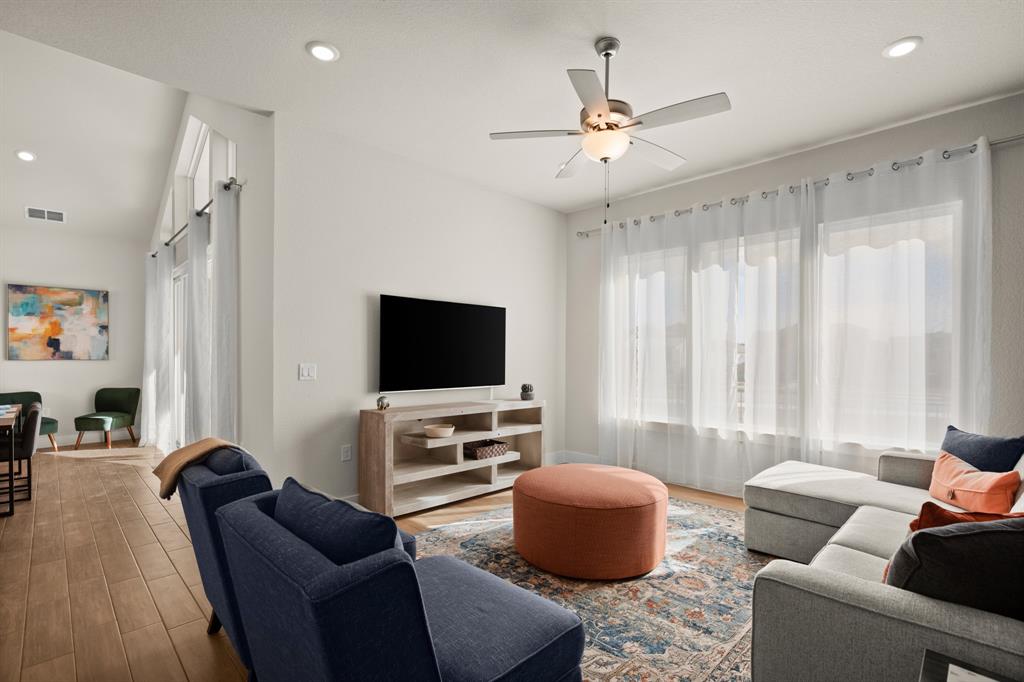 8810 Bestride Bend Austin, TX 78744 - Photo 18 of 35 a living room with furniture and a flat screen tv