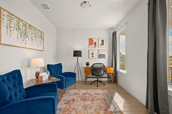 a living room with furniture and a rug