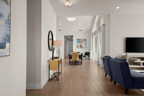 a view of a livingroom with furniture and a flat screen tv