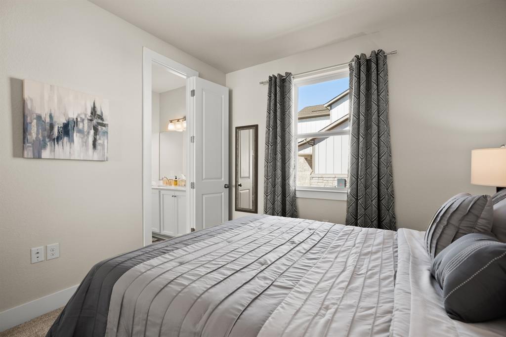 8810 Bestride Bend Austin, TX 78744 - Photo 28 of 35 a bedroom with a large bed and a painting on the wall