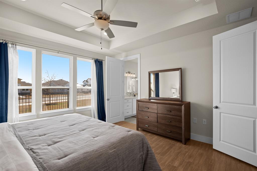 8810 Bestride Bend Austin, TX 78744 - Photo 30 of 35 a bedroom with a bed dresser and a large window