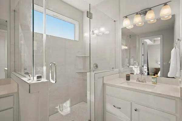 a bathroom with a double vanity sink and a mirror