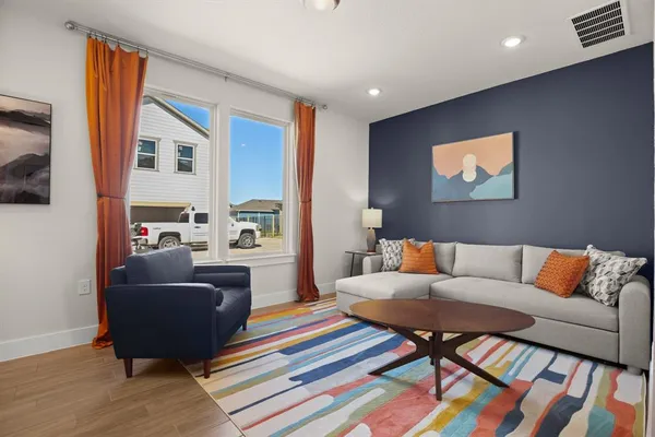 a living room with furniture and a rug