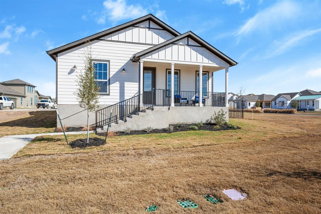 8810 Bestride Bend Austin, TX 78744 - Photo 4 of 35 a front view of a house with garden