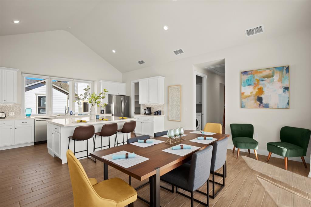 8810 Bestride Bend Austin, TX 78744 - Photo 5 of 35 a view of a dining room with furniture and wooden floor