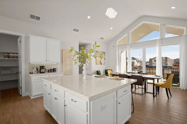 a kitchen with counter top space and windows